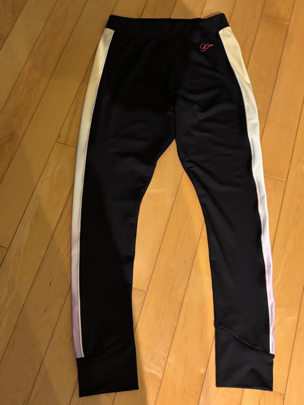 Sophia Webster PUMA black sports leggings with light yellow and purple stripes